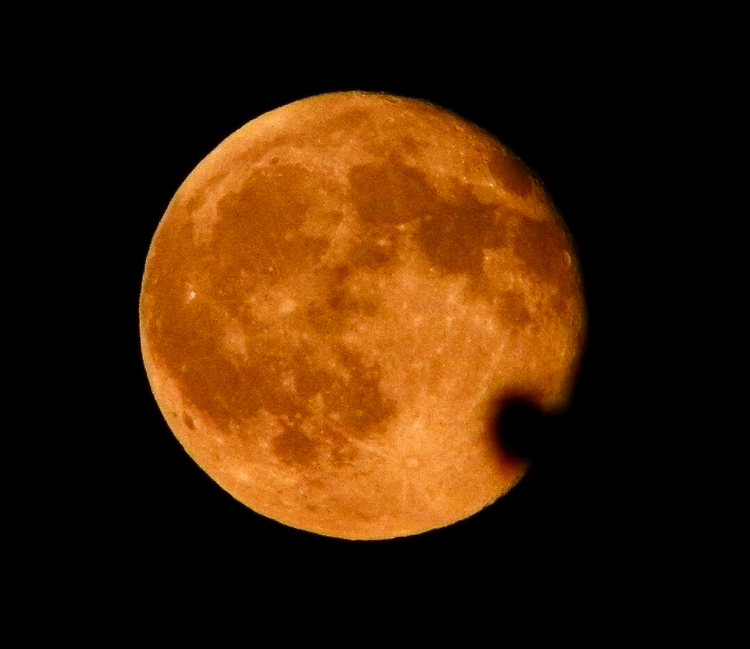 Full moon rising, amber and orange